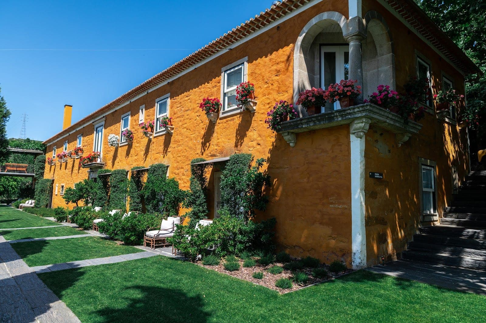Vine terraces and the schist-clad winery buildings of Quinta do Vallado on the Corgo river