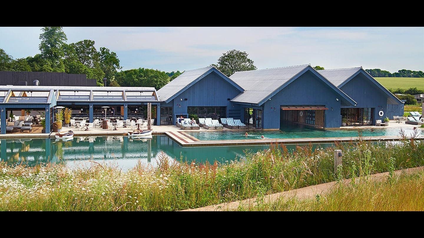 Timber cabins and converted barns across the Soho Farmhouse estate at Great Tew
