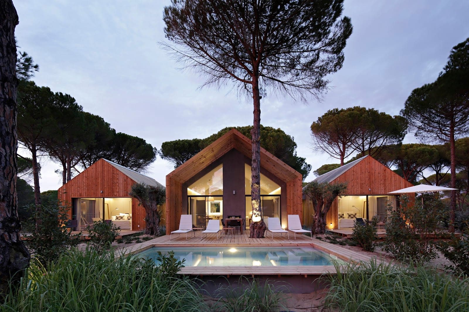 Thatched cabanas among umbrella pines at Sublime Comporta in the Alentejo