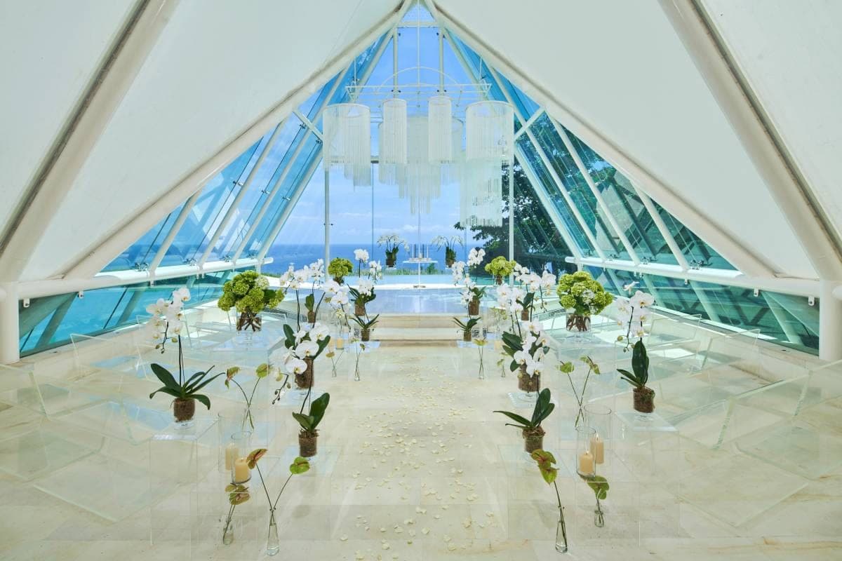 Tirtha Uluwatu’s white Glass Chapel standing above a reflecting pool on the Bali clifftop
