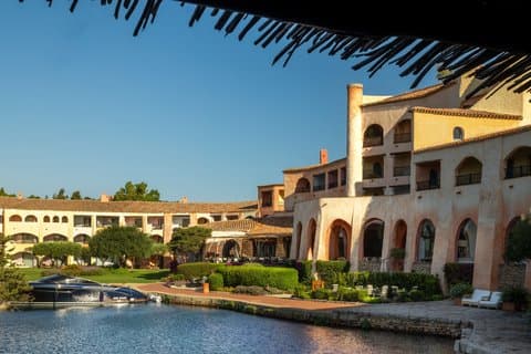 Hotel Cala di Volpe on its bay in the Costa Smeralda, curved walls above clear water