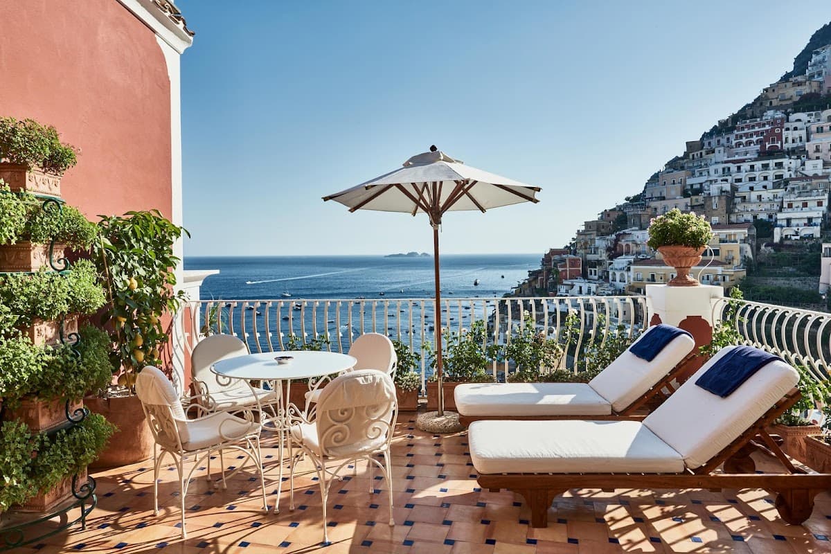 Le Sirenuse above Positano, terraces stepping down towards the sea and the dome