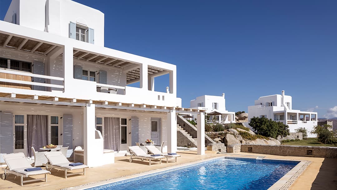 Stone villas with private pools stepping down the Stelida hillside at the Naxian Collection, Naxos